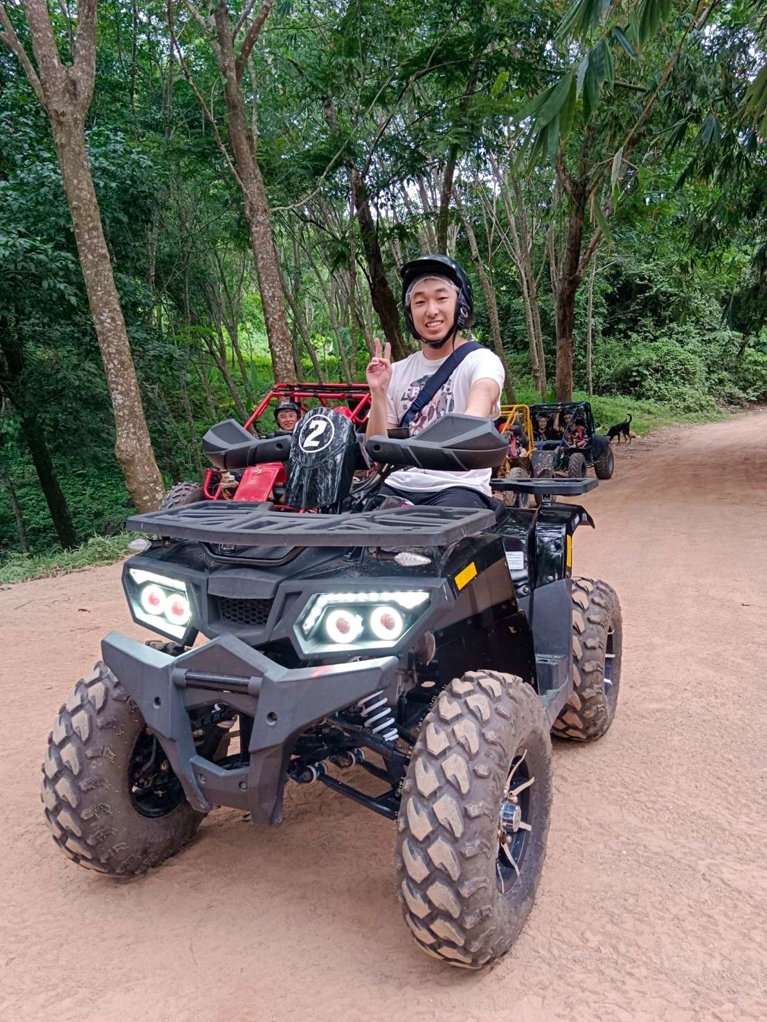 Solo rider on a 450cc black ATV in the jungle