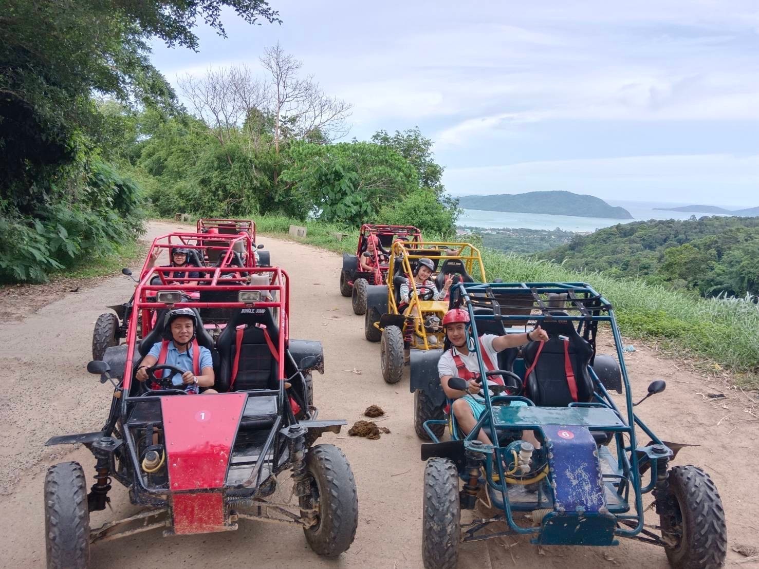Buggies parked at a Phuket viewpoint overlooking the sea