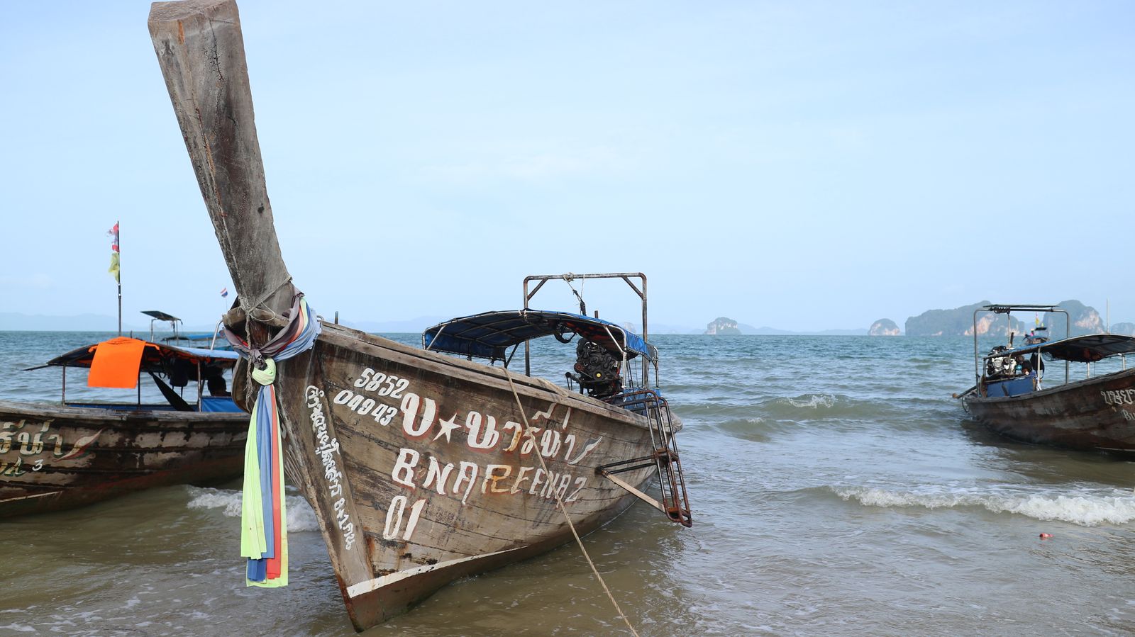 Traditional Thai longtail boats on the shoreline
