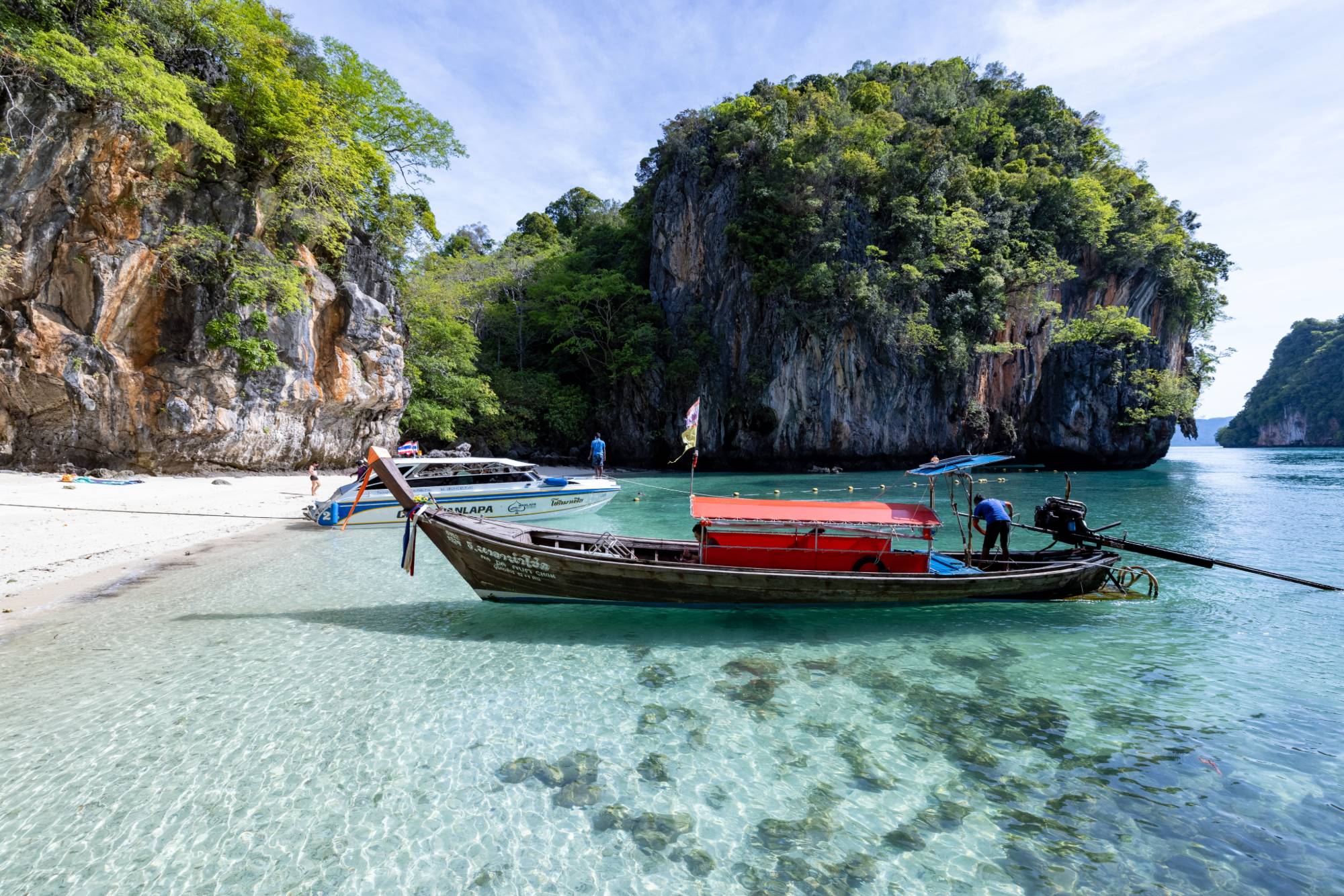 Traditional Thai longtail boat with painted prow ribbons