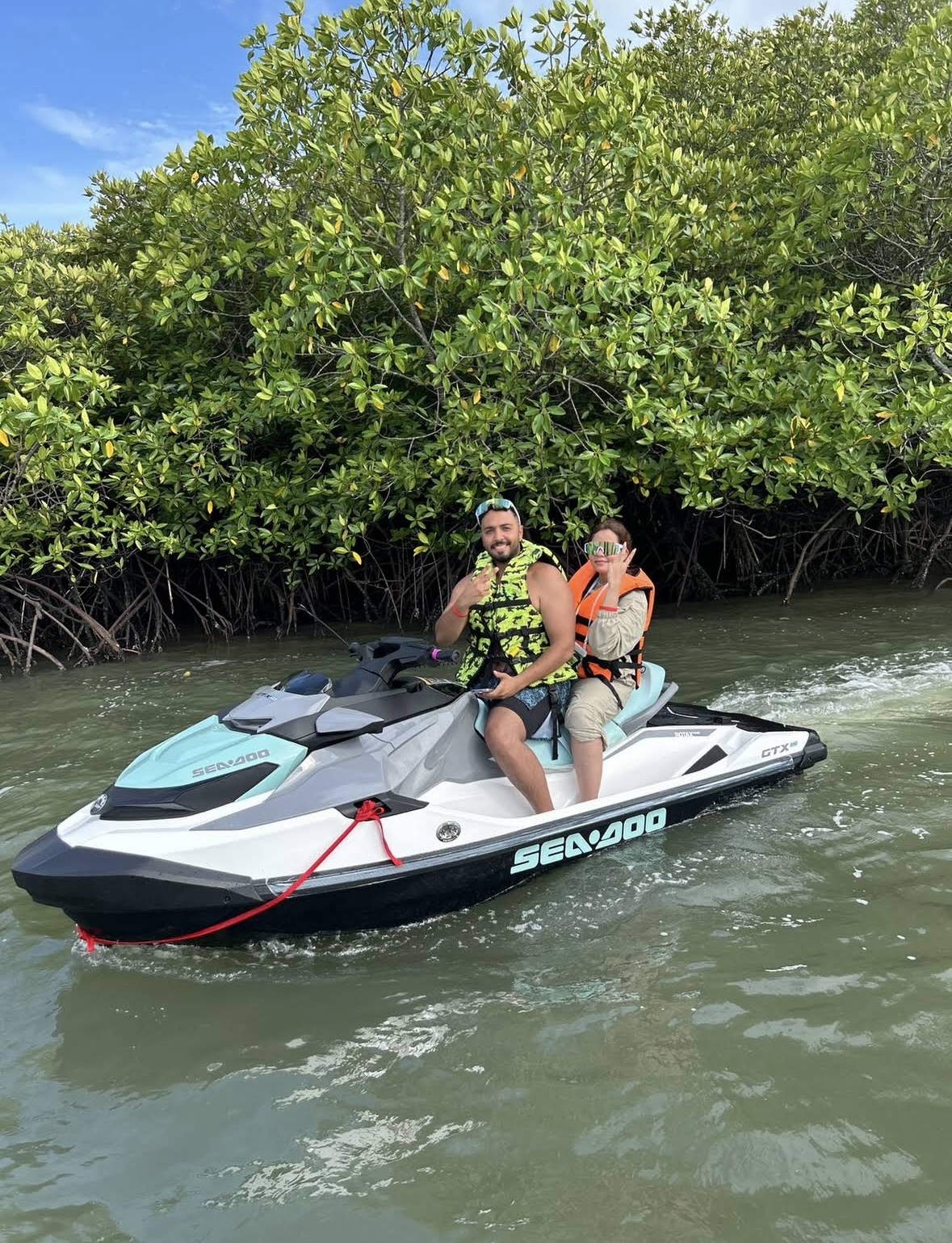 Couple on a Sea-Doo jetski riding through the mangrove forest