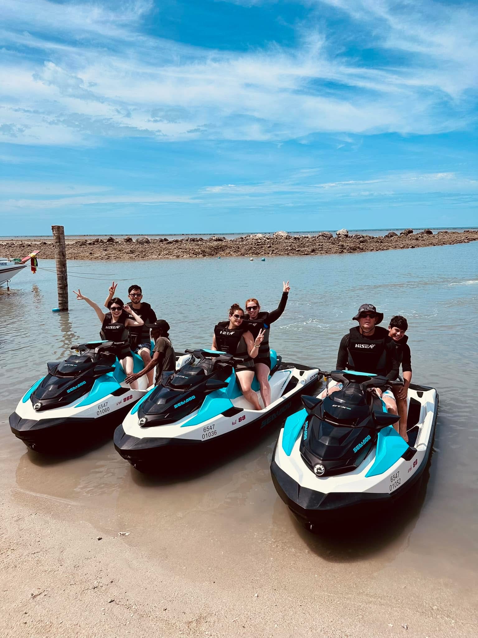 Group of friends posing on Sea-Doos