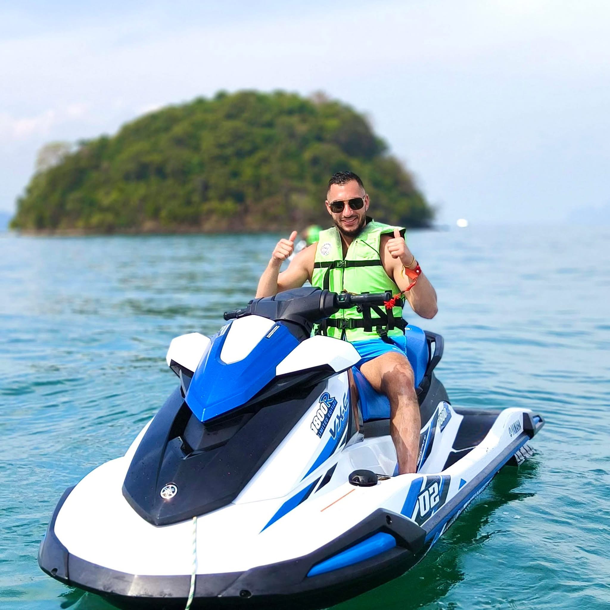 Solo rider on a Yamaha jetski with island behind